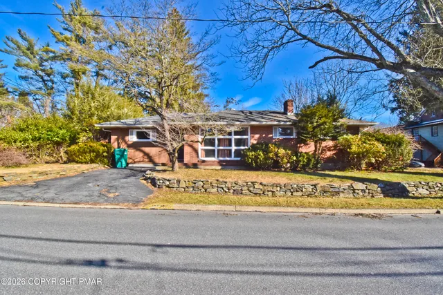 a view of a house with a yard and sitting area