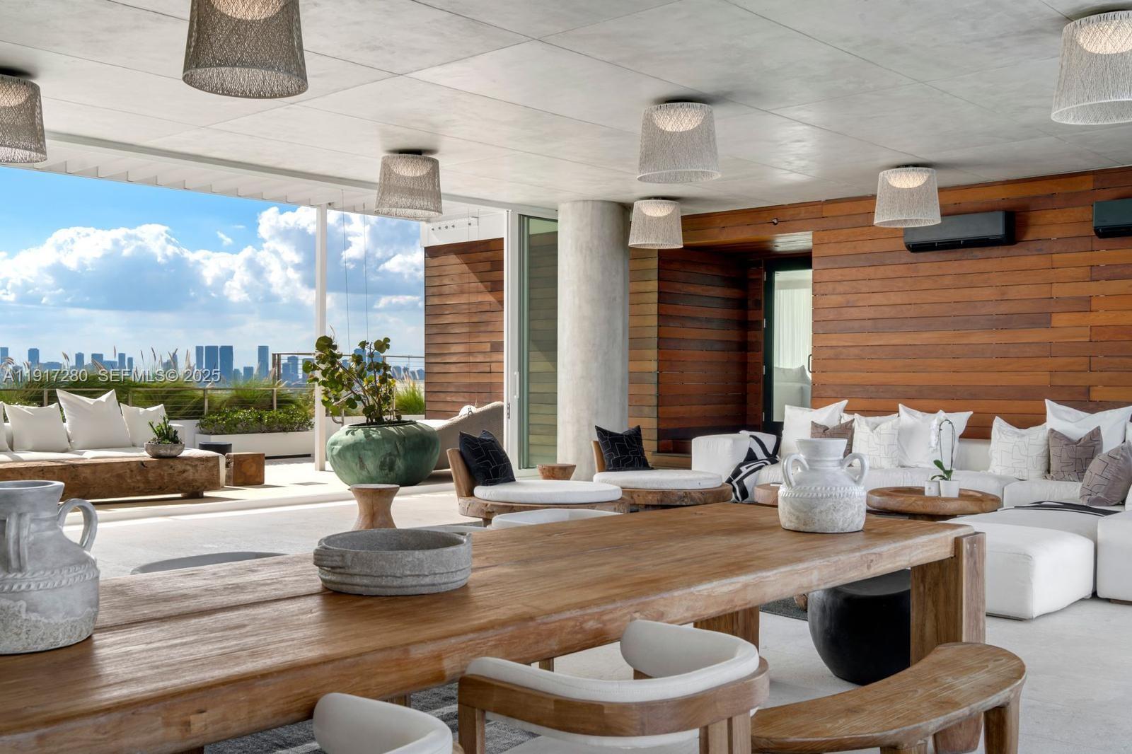 4701 Meridian Avenue, Unit UPH21 Miami Beach, FL 33140 - Photo 2 of 40 a kitchen with a table and chairs