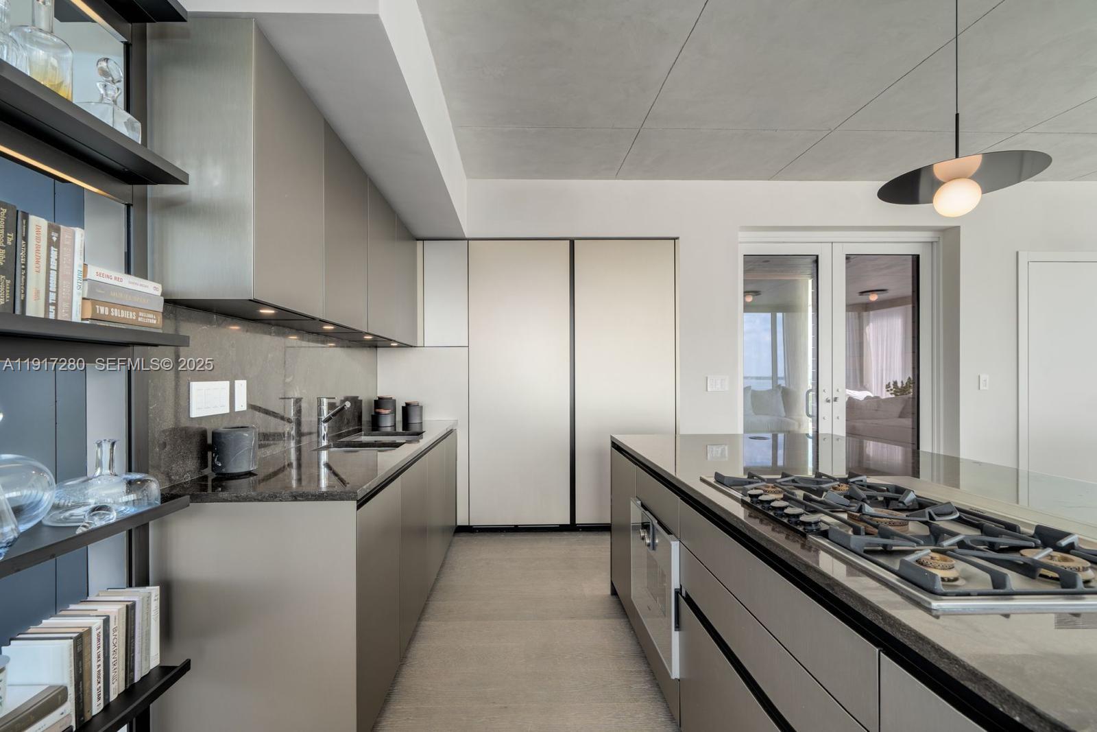 4701 Meridian Avenue, Unit UPH21 Miami Beach, FL 33140 - Photo 23 of 40 a kitchen with stainless steel appliances granite countertop a stove and a sink