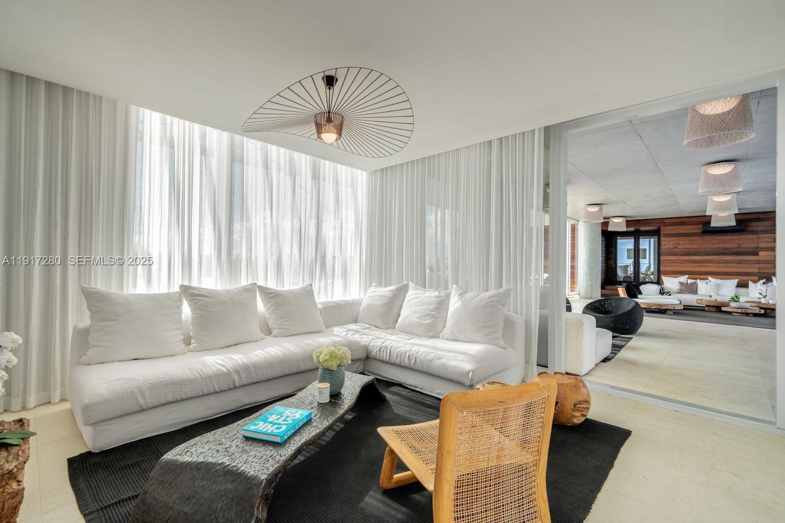 4701 Meridian Avenue, Unit UPH21 Miami Beach, FL 33140 - Photo 37 of 40 a living room with furniture and a large window