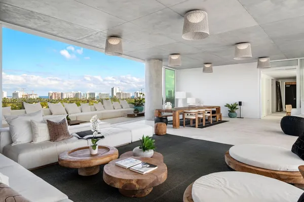 a living room with furniture and a kitchen view