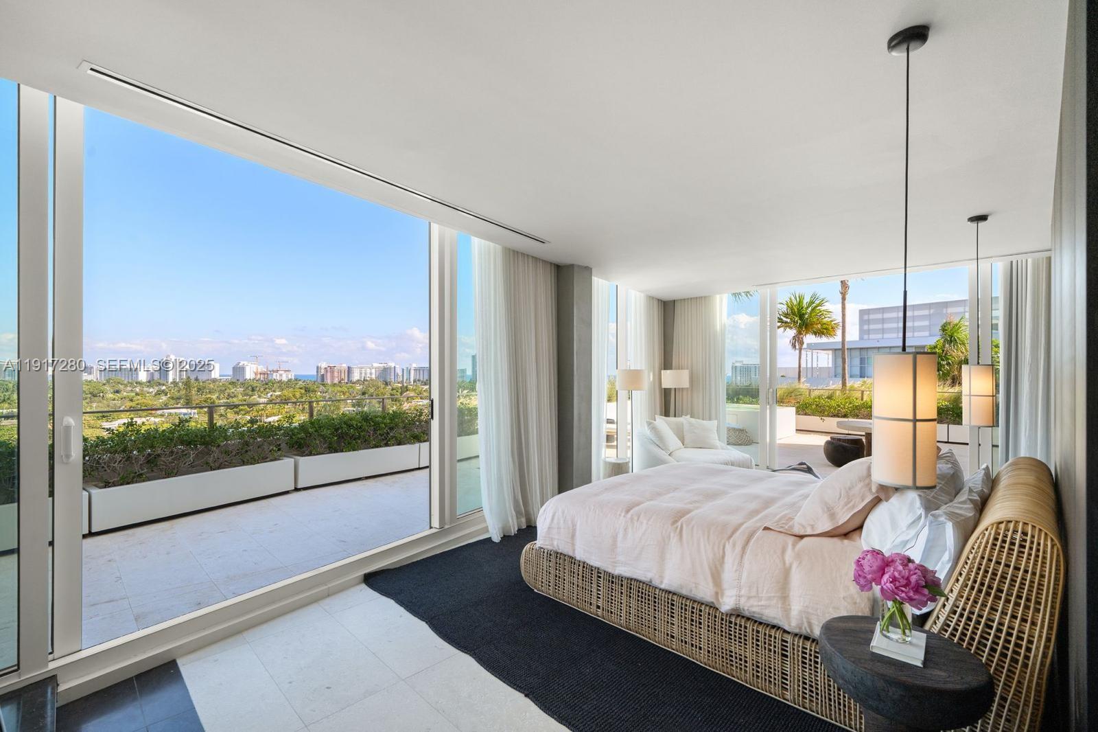 4701 Meridian Avenue, Unit UPH21 Miami Beach, FL 33140 - Photo 6 of 40 a bedroom with a bed and large windows