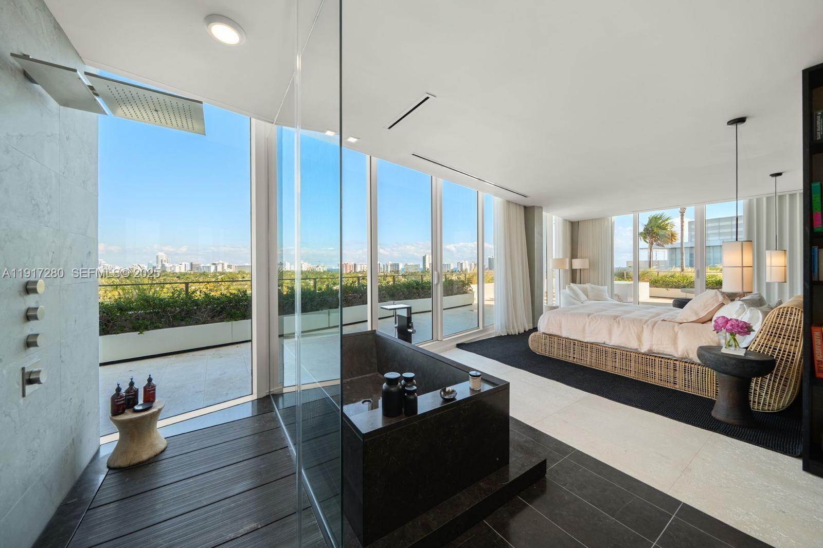 4701 Meridian Avenue, Unit UPH21 Miami Beach, FL 33140 - Photo 8 of 40 a living room with furniture and a flat screen tv
