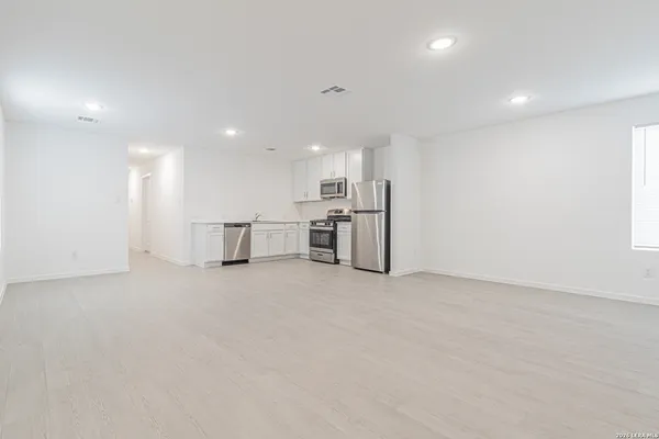 a view of a kitchen with a sink and microwave