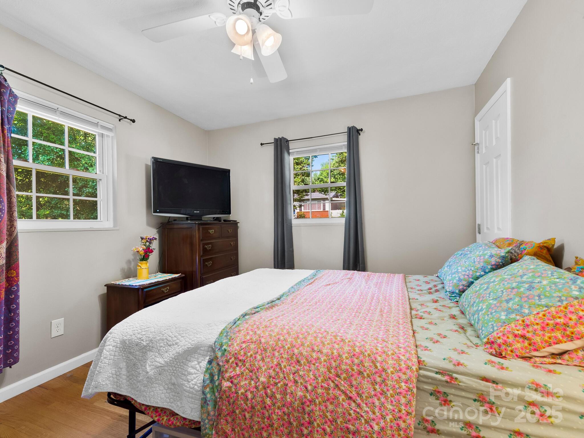 8 Vista Knoll Road Candler, NC 28715 - Photo 12 of 32 a bedroom with a bed and a flat screen tv