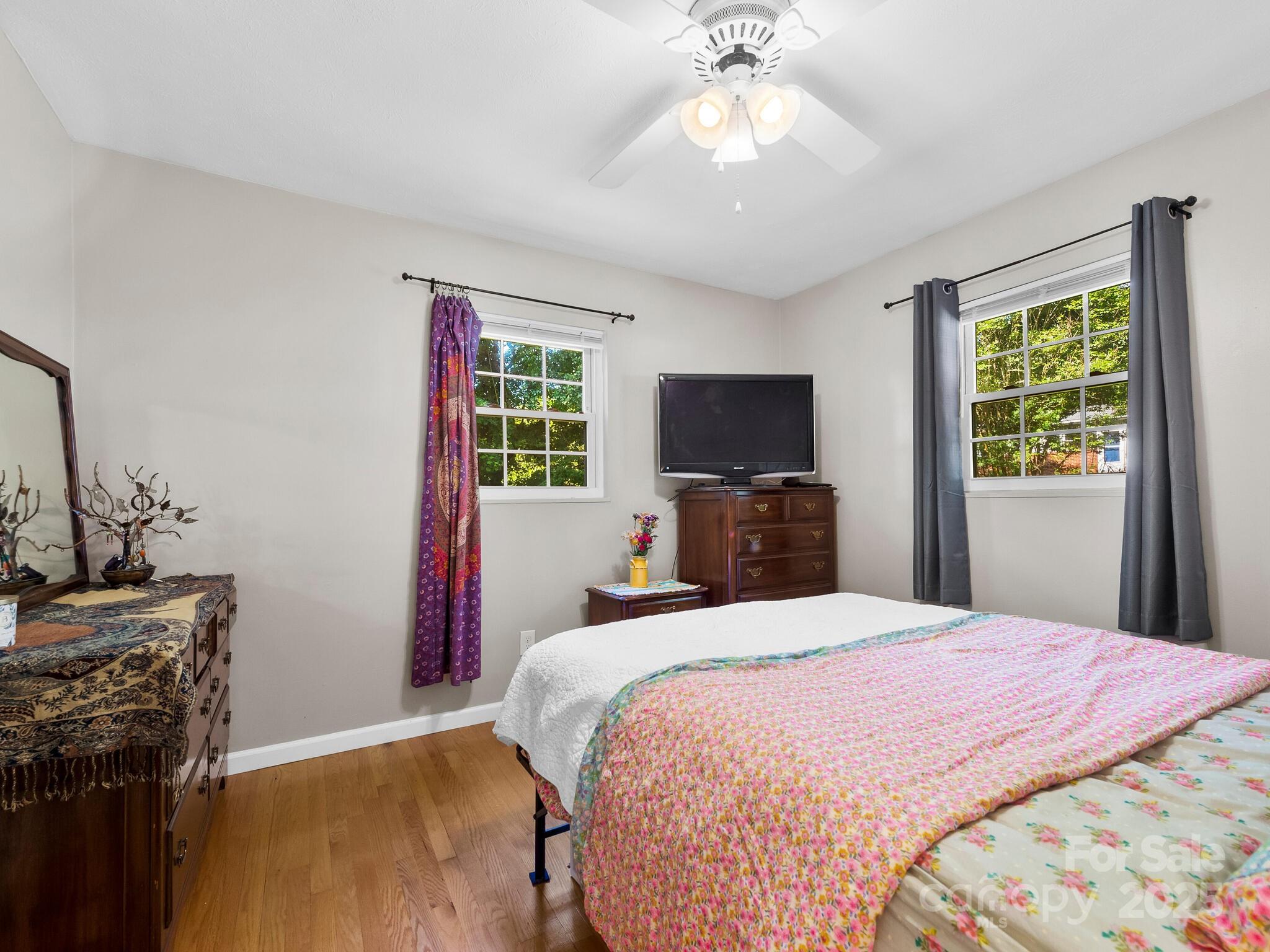 8 Vista Knoll Road Candler, NC 28715 - Photo 13 of 32 a bedroom with a bed and a flat screen tv