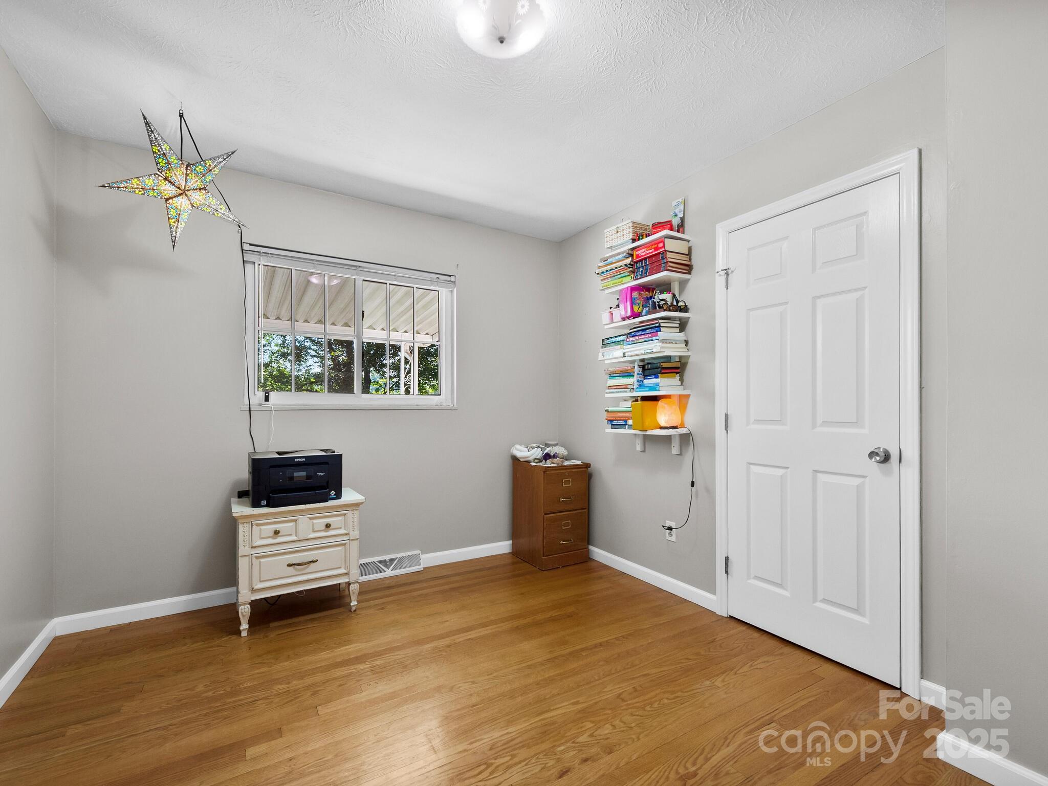 8 Vista Knoll Road Candler, NC 28715 - Photo 14 of 32 a bedroom with a bed and a window