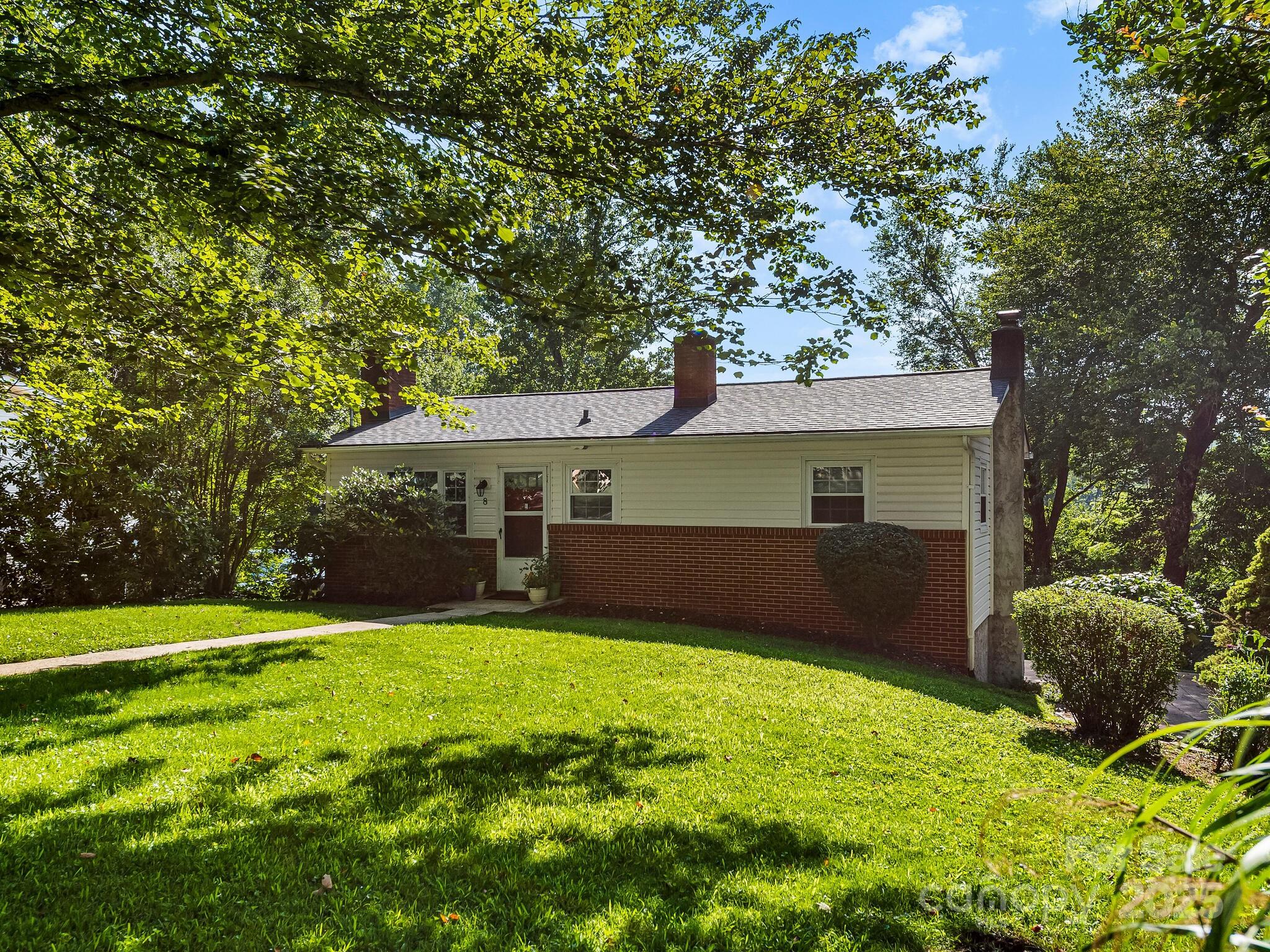 8 Vista Knoll Road Candler, NC 28715 - Photo 2 of 32 a front view of a house with garden