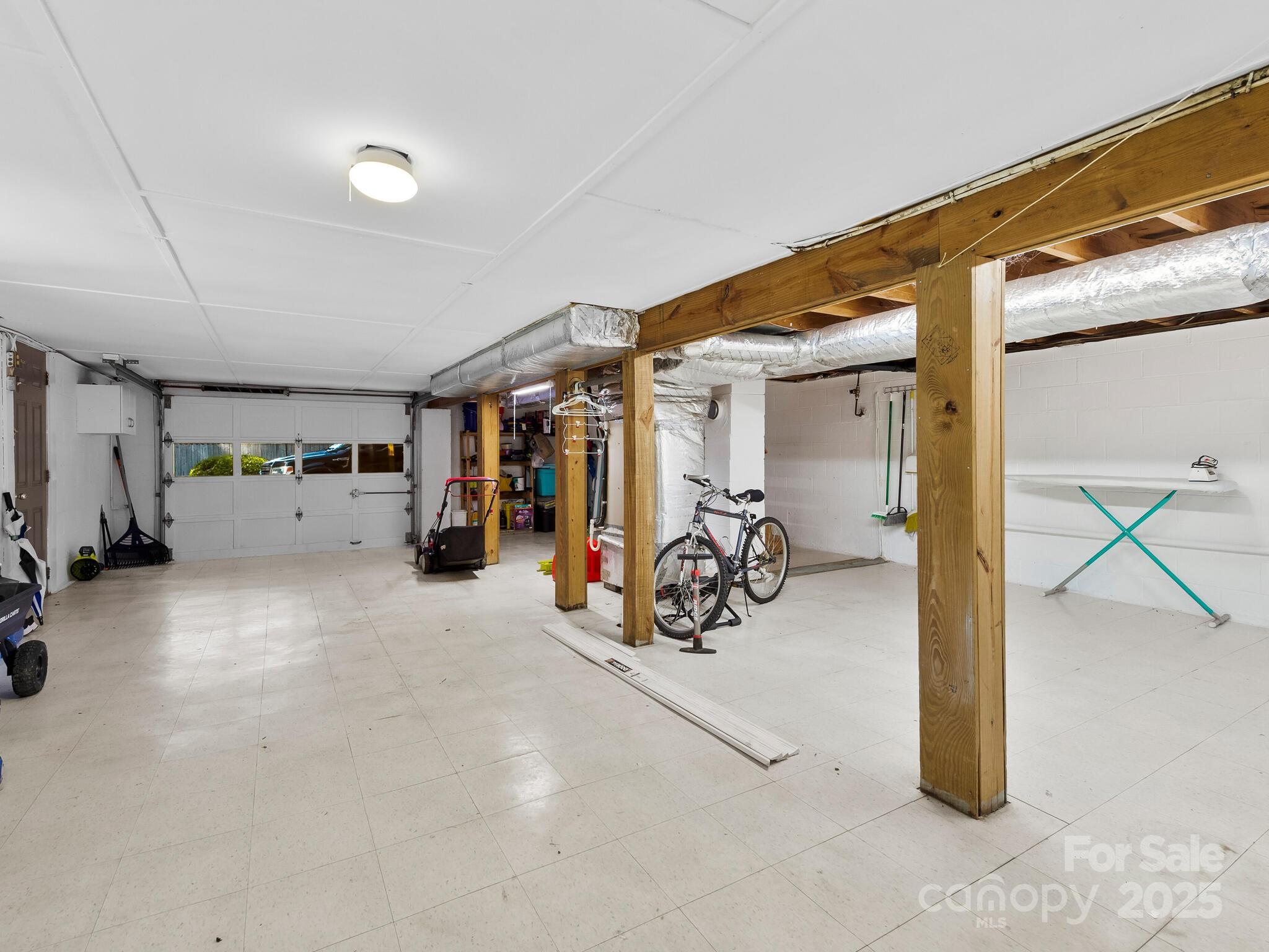 8 Vista Knoll Road Candler, NC 28715 - Photo 22 of 32 a view of a garage with rack and bicycle