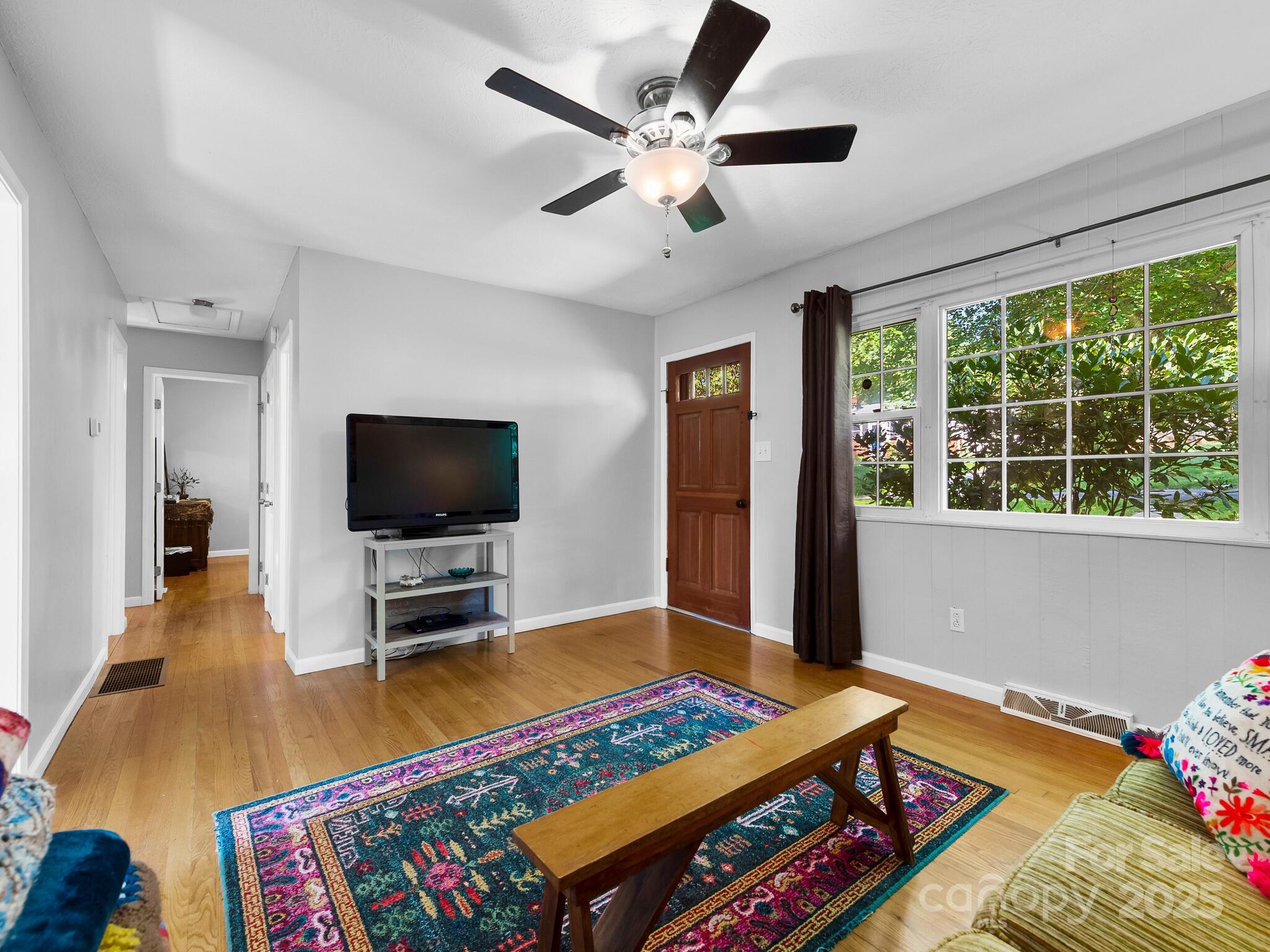 8 Vista Knoll Road Candler, NC 28715 - Photo 5 of 32 a bedroom with furniture and a flat screen tv