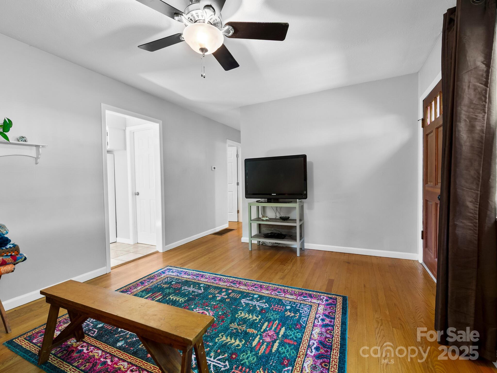 8 Vista Knoll Road Candler, NC 28715 - Photo 6 of 32 a living room with furniture and a flat screen tv