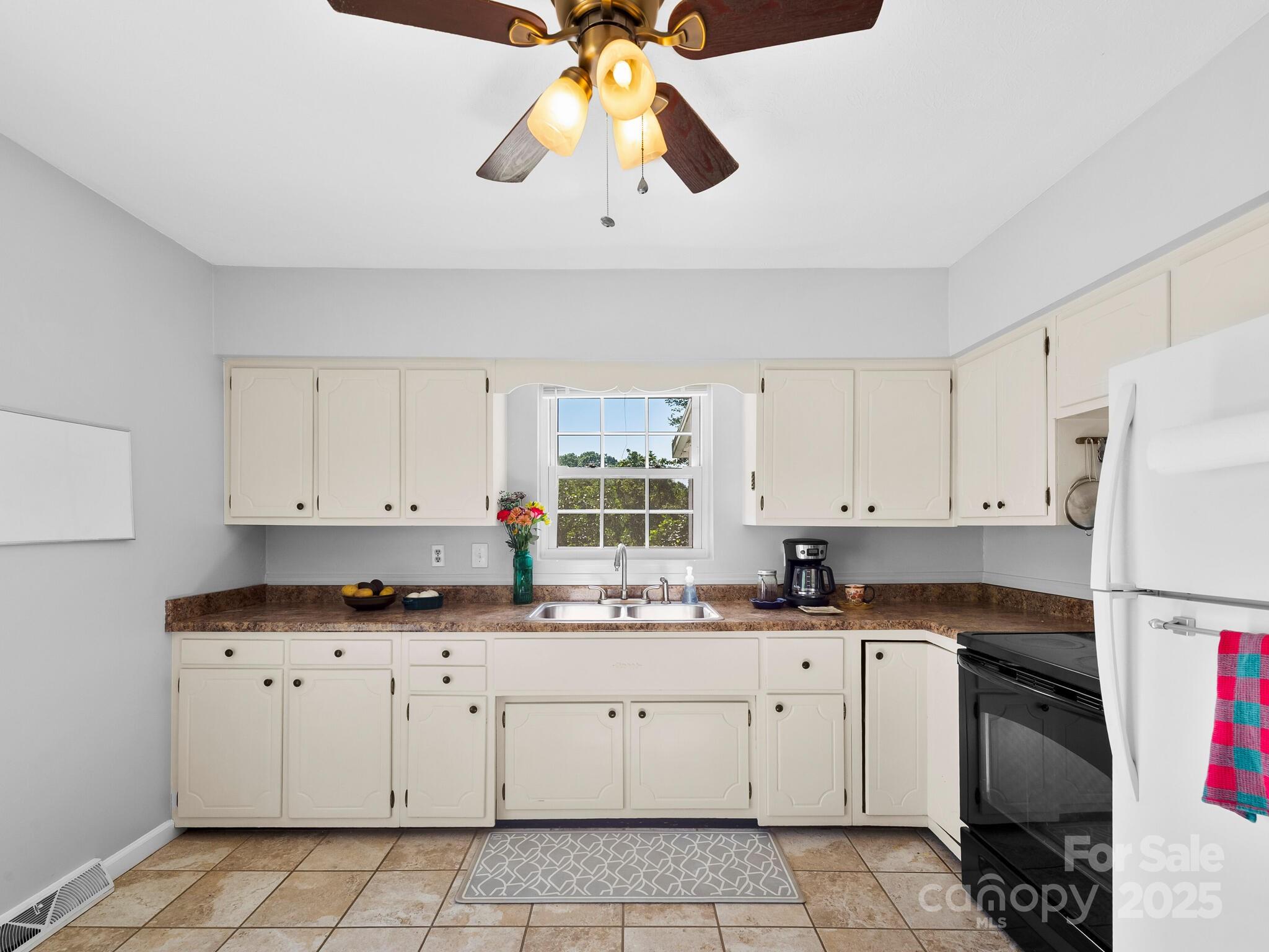 8 Vista Knoll Road Candler, NC 28715 - Photo 9 of 32 a kitchen with granite countertop white cabinets white stainless steel appliances with a sink and dishwasher