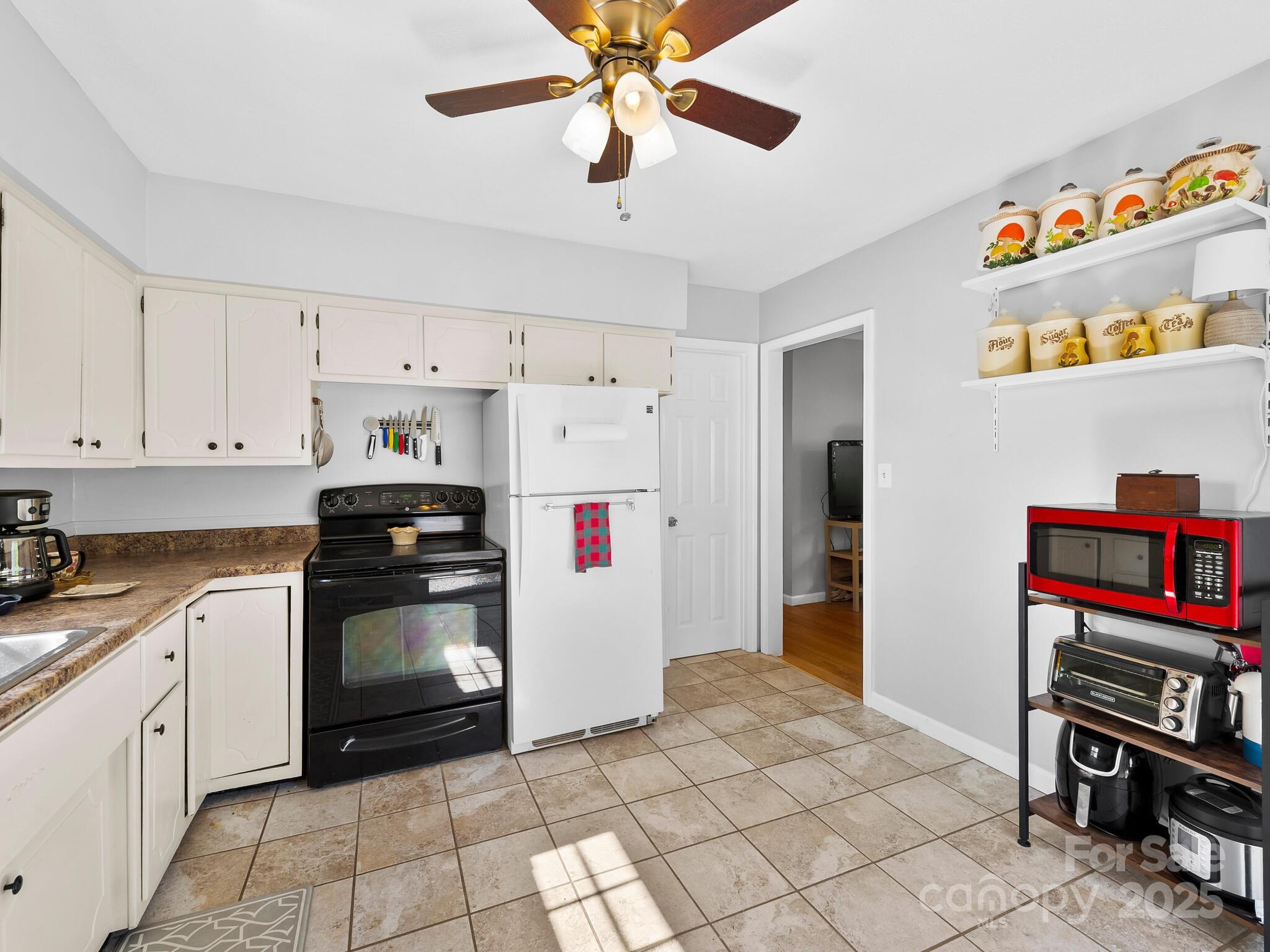 8 Vista Knoll Road Candler, NC 28715 - Photo 10 of 32 a kitchen with stainless steel appliances granite countertop a refrigerator and a stove top oven