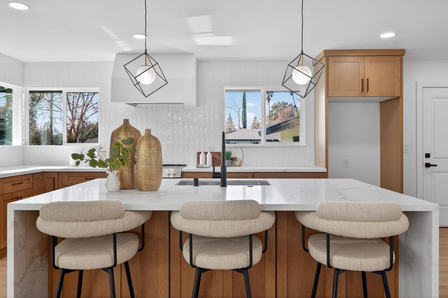 2546 El Vita Way Carmichael, CA 95608 - Photo 13 of 52 a kitchen with stainless steel appliances granite countertop a dining table chairs and a chandelier