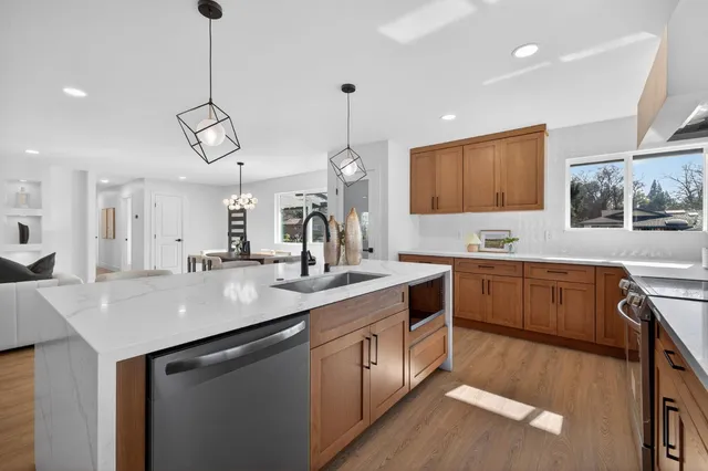 a kitchen with a sink cabinets and window