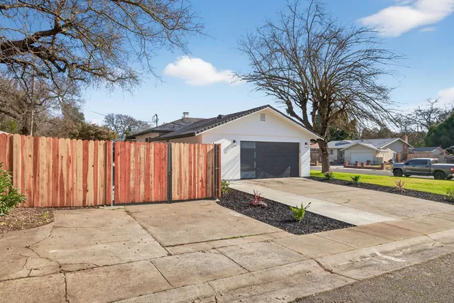 a view of a house with swimming pool and a yard