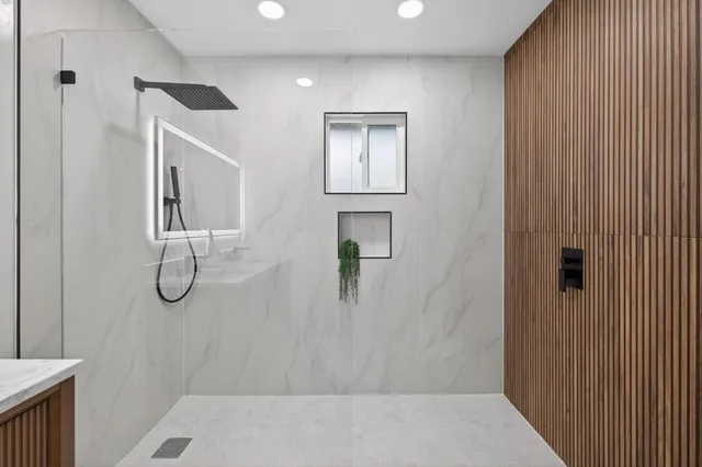 a bathroom with a glass shower door