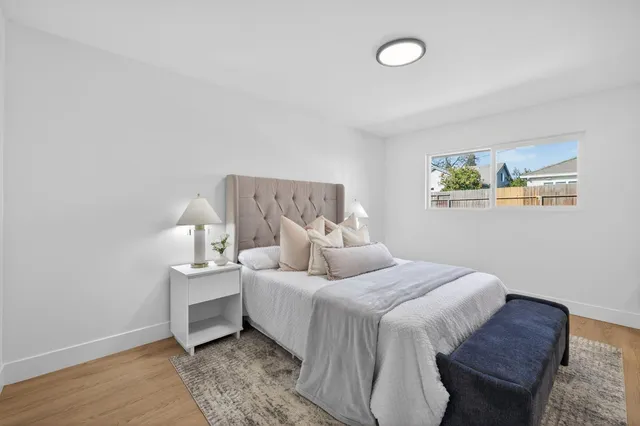 a bedroom with bed and a night stand