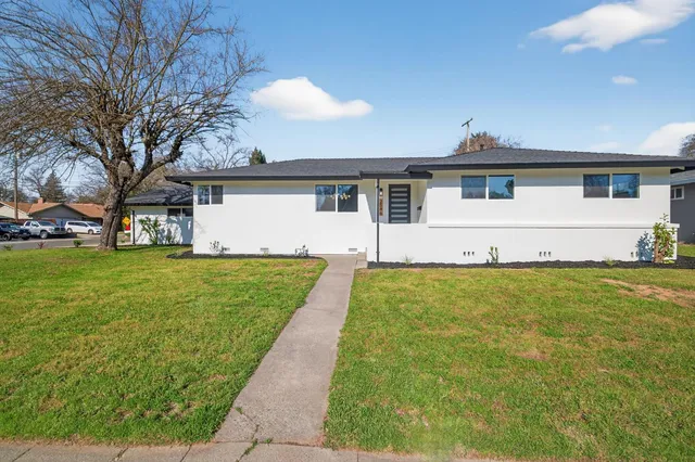 a front view of house with yard and green space