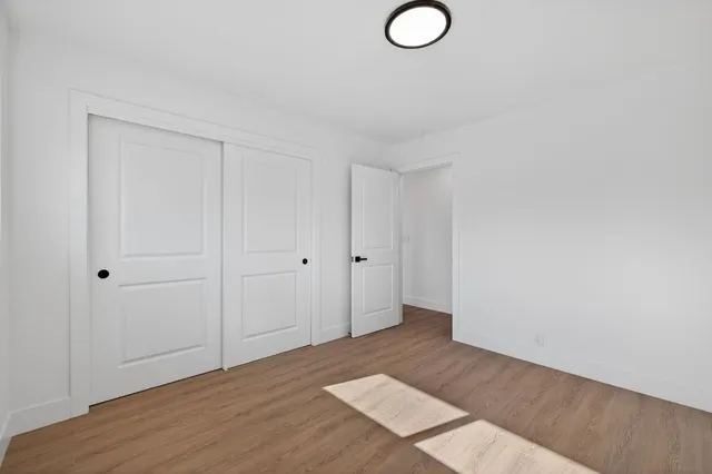 a view of a room with wooden floor
