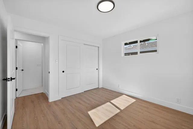 a view of a room with wooden floor and bathroom