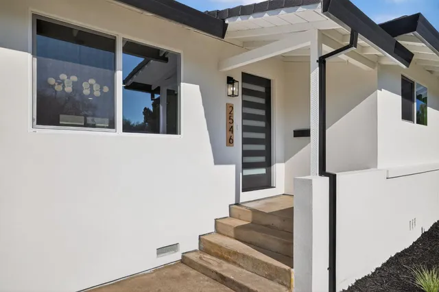 a view of staircase with lots of frames and door