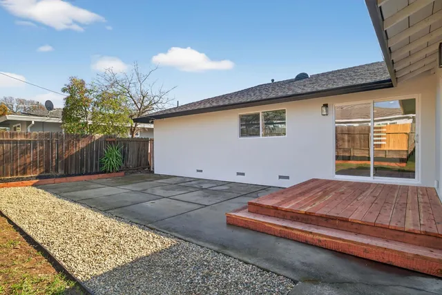 a view of backyard with a patio and a yard