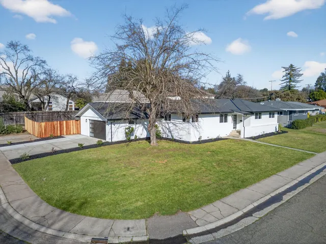 a view of a house with a backyard porch and sitting area
