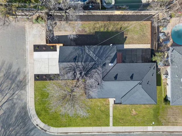 an aerial view of a house with a swimming pool
