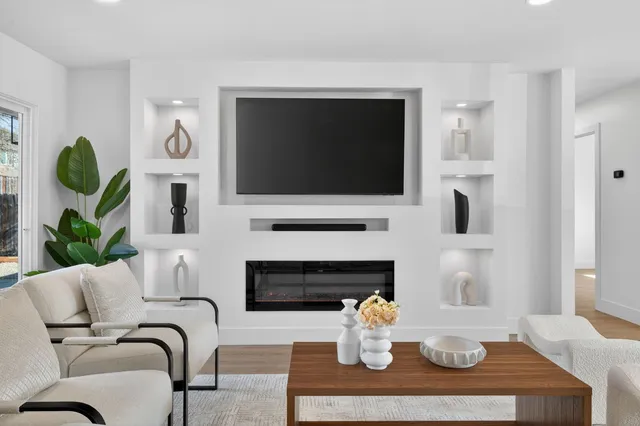 a living room with furniture a fireplace and a flat screen tv