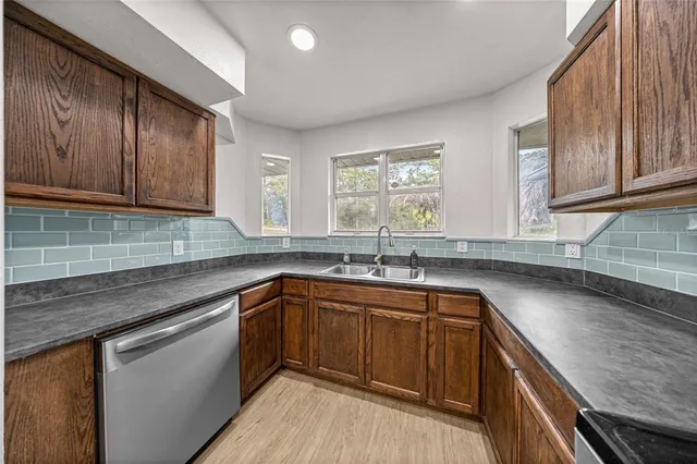 a kitchen with a sink stove and cabinets