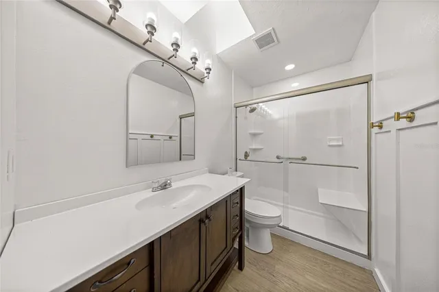 a bathroom with a double vanity sink toilet and shower