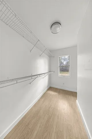 a view of a room with wooden floor and white walls