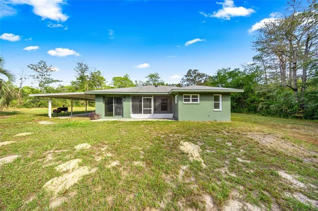 a view of a house with a backyard