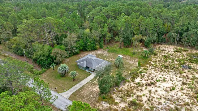 an aerial view of residential house with outdoor space