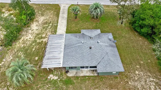 a view of a yard with chairs
