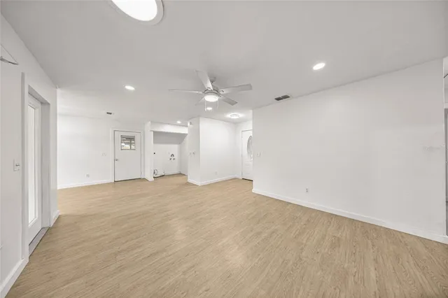 a view of an empty room with a kitchen
