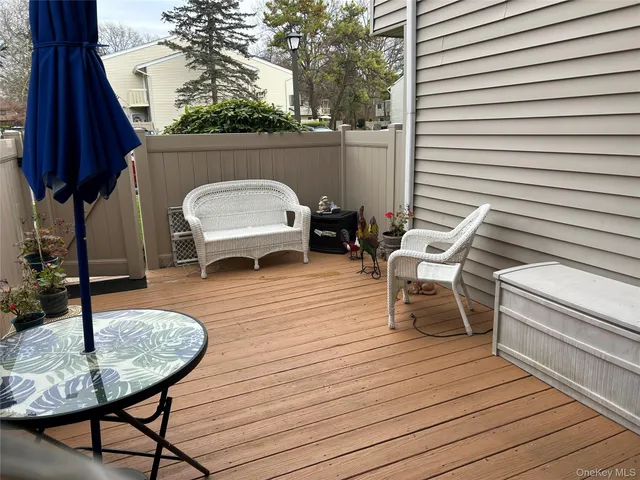 a balcony with table and chairs