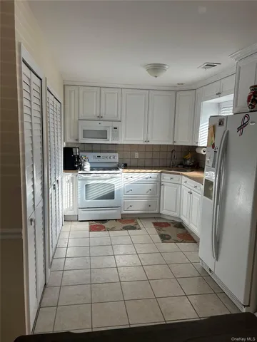 a kitchen with stainless steel appliances a refrigerator sink and cabinets