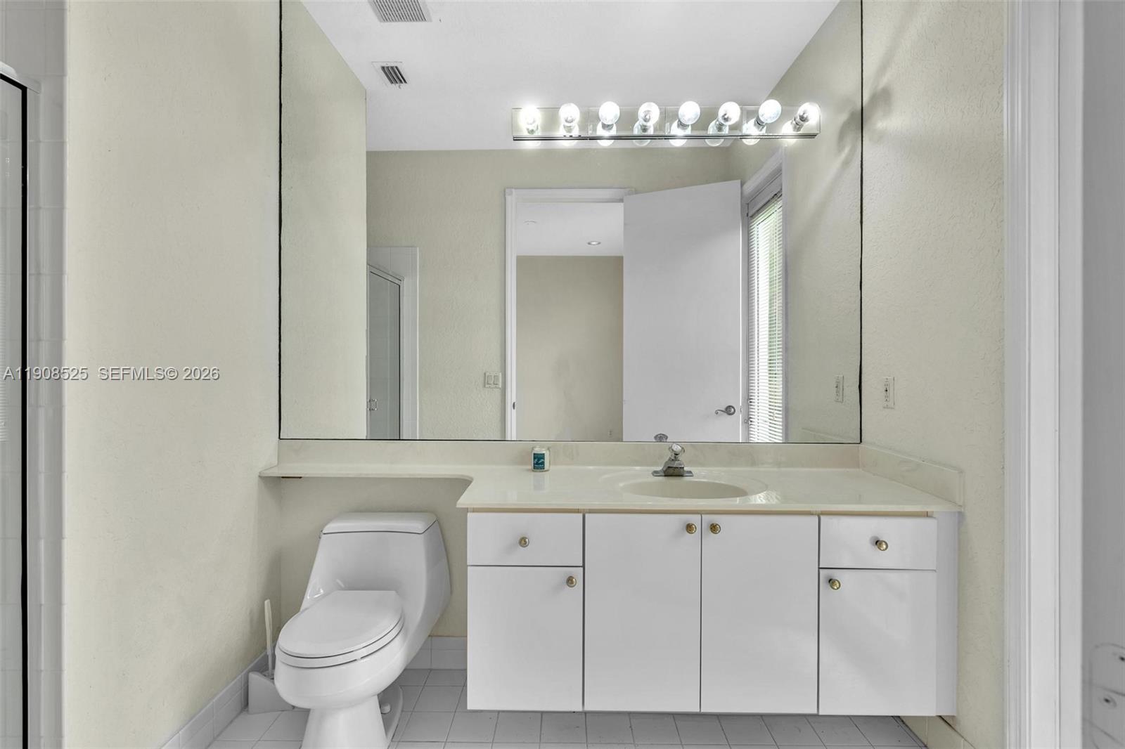 18579 Harbor Light Way Boca Raton, FL 33498 - Photo 14 of 30 a bathroom with a toilet sink and mirror