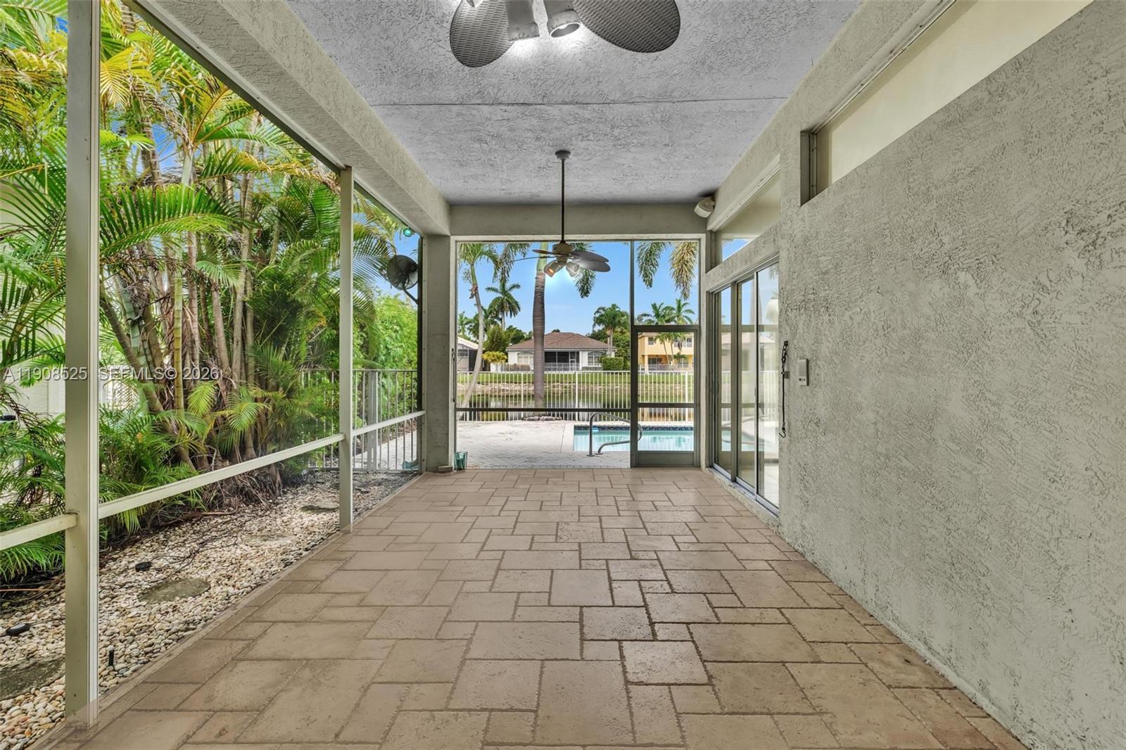 18579 Harbor Light Way Boca Raton, FL 33498 - Photo 18 of 30 a view of a room with a large window and chandelier