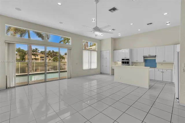 a large white kitchen with cabinets and a stove