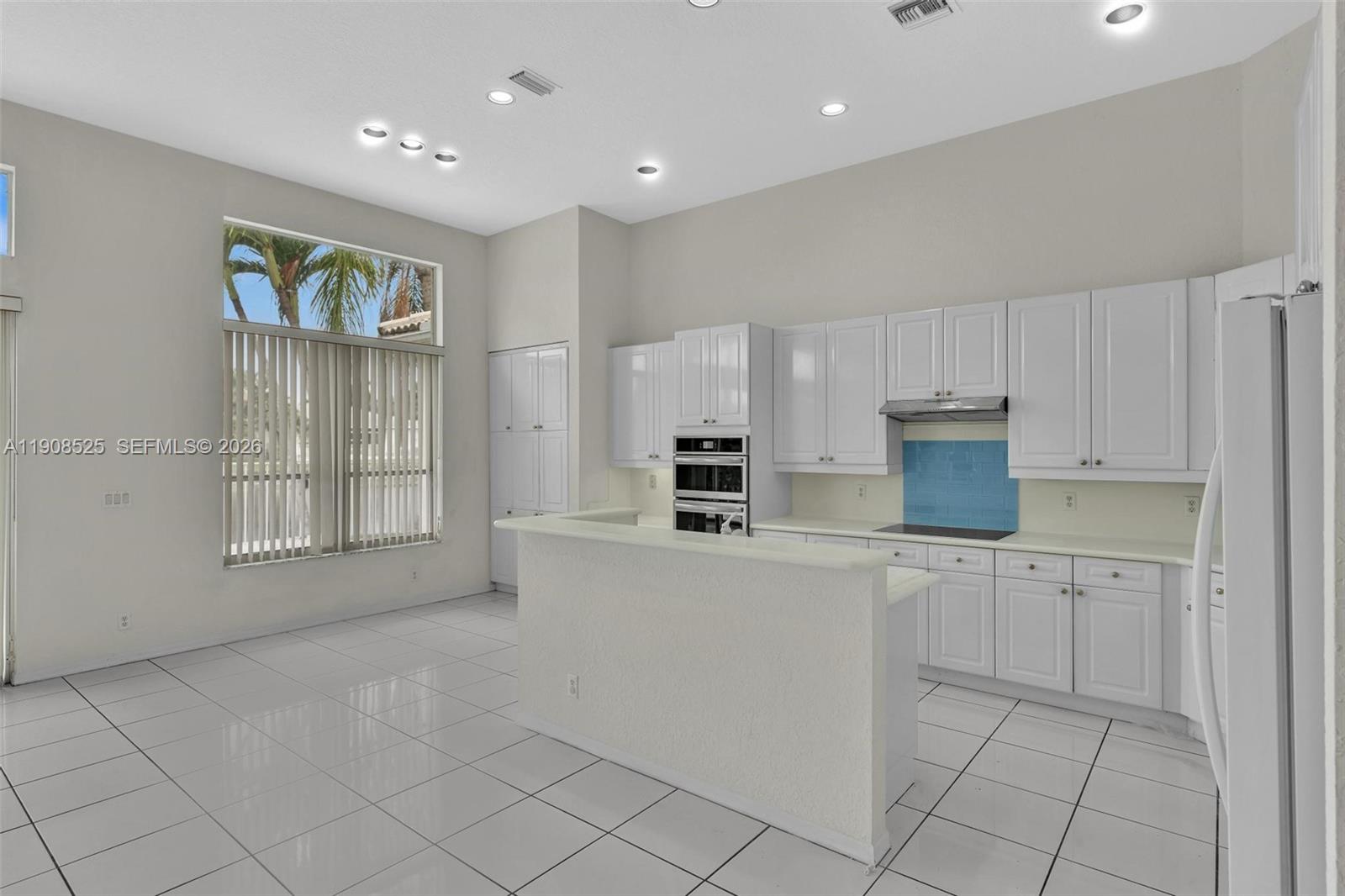 18579 Harbor Light Way Boca Raton, FL 33498 - Photo 7 of 30 a kitchen with cabinets and window