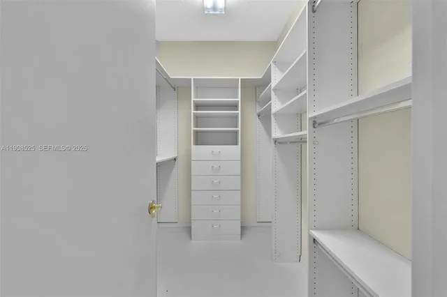 a view of walk in closet with empty racks
