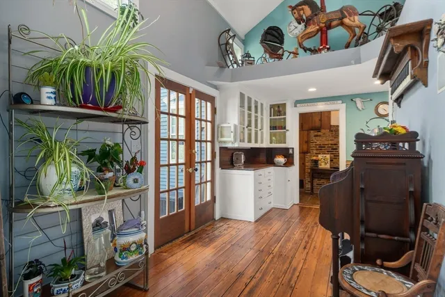 a living room with furniture a piano and a fireplace