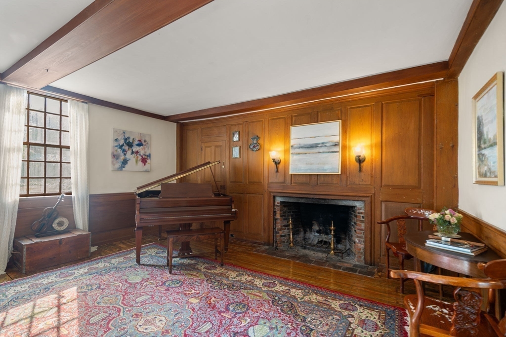 100 Eliot Street Natick, MA 01760 - Photo 17 of 41 a living room with furniture a piano and a fireplace
