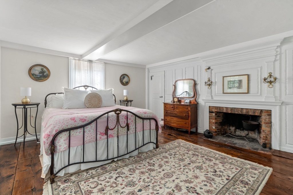 100 Eliot Street Natick, MA 01760 - Photo 29 of 41 a bedroom with a bed and a fireplace