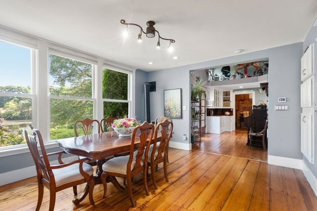 a living room with furniture and a piano