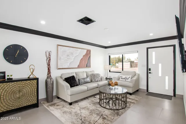 a kitchen with a sink a stove and chairs