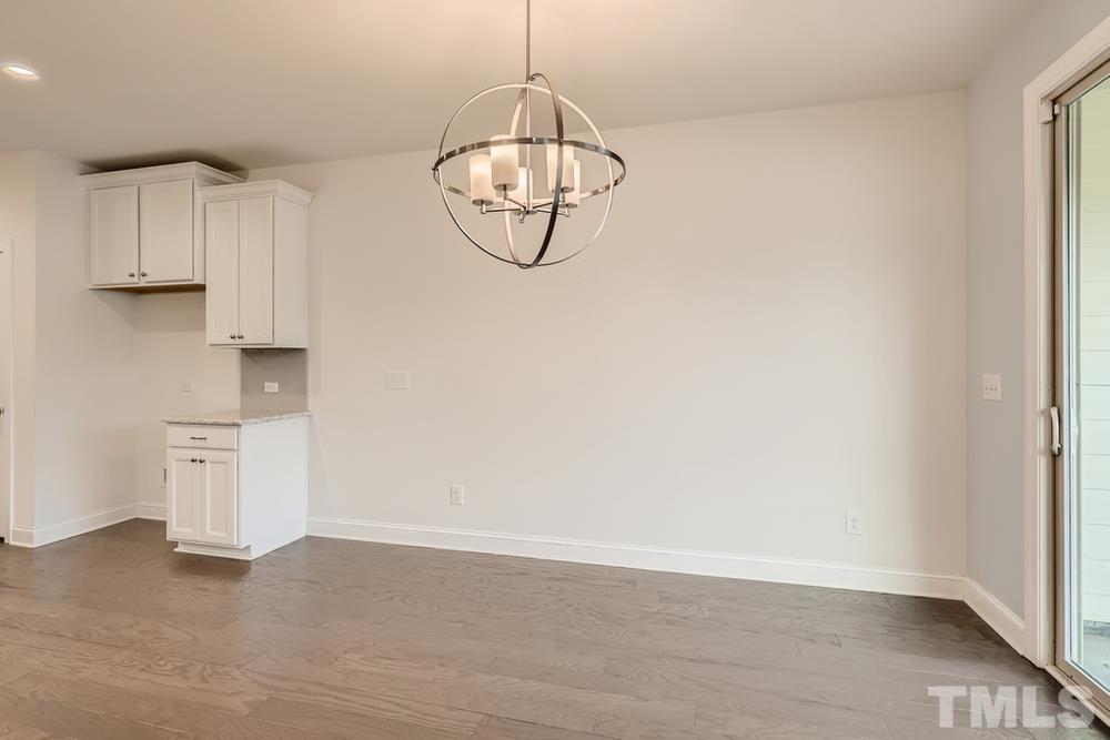 1207 Catch Fly Lane Durham, NC 27713 - Photo 11 of 28 a view of a room with wooden floor and ceiling fan